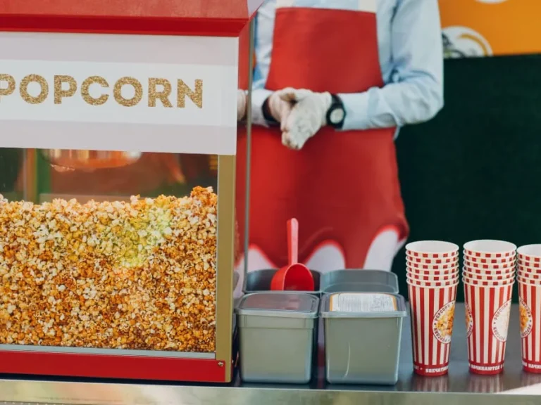 Popcorn machine with striped popcorn boxes at a party